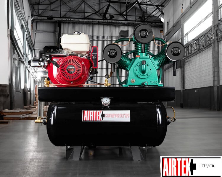 Heavy-duty Airtek industrial air compressor featuring red and green motors installed inside spacious warehouse - Airtek air compressor systems for industry