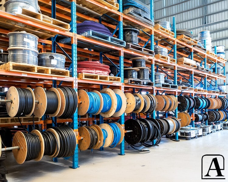 Warehouse rack filled with different types of Amiflex industrial hoses, showcasing range, durability, and organization for fast industrial deployment