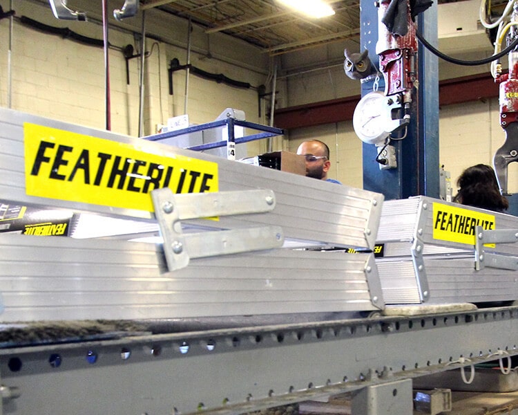 Featherlite aluminum beams on industrial assembly line showcasing premium Featherlite ladders and equipment - Industrial ladder supplier