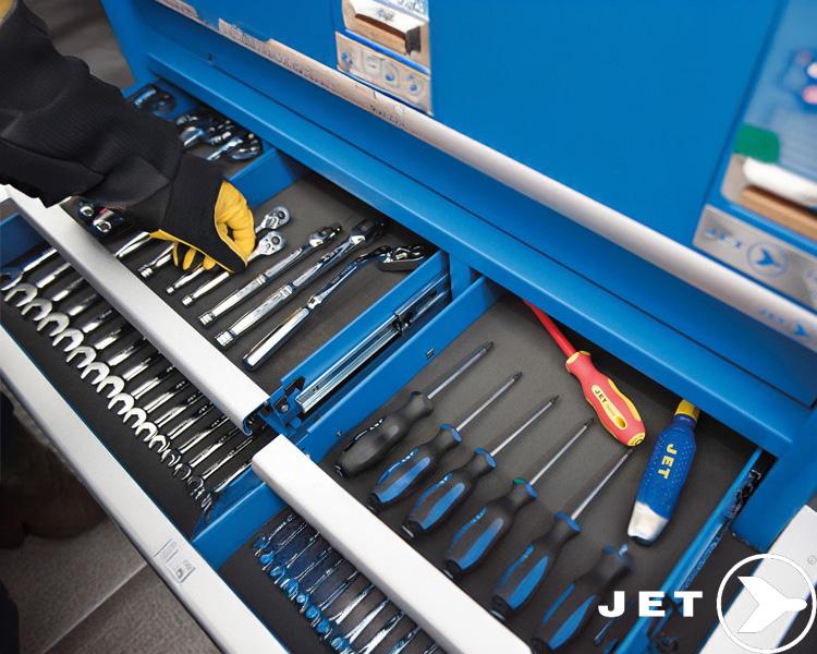 Person wearing gloves opening Jet tool cabinet drawer with organized wrenches and screwdrivers, displaying Jet Tools brand