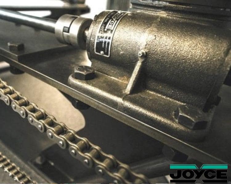 Close-up of Joyce machine component with chain, highlighting intricate details and high-quality construction