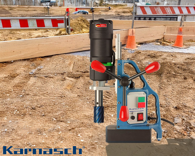 Karnasch Mag-drill positioned on a construction site, ready for use, showcasing its durable build and functionality with the Karnasch logo visible