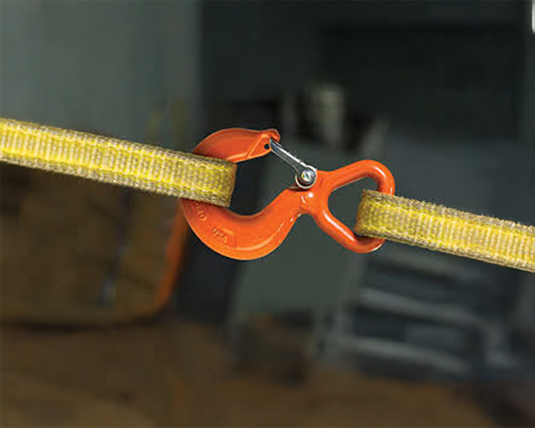 Two heavy-duty yellow lifting slings attached to an orange crane hook in motion