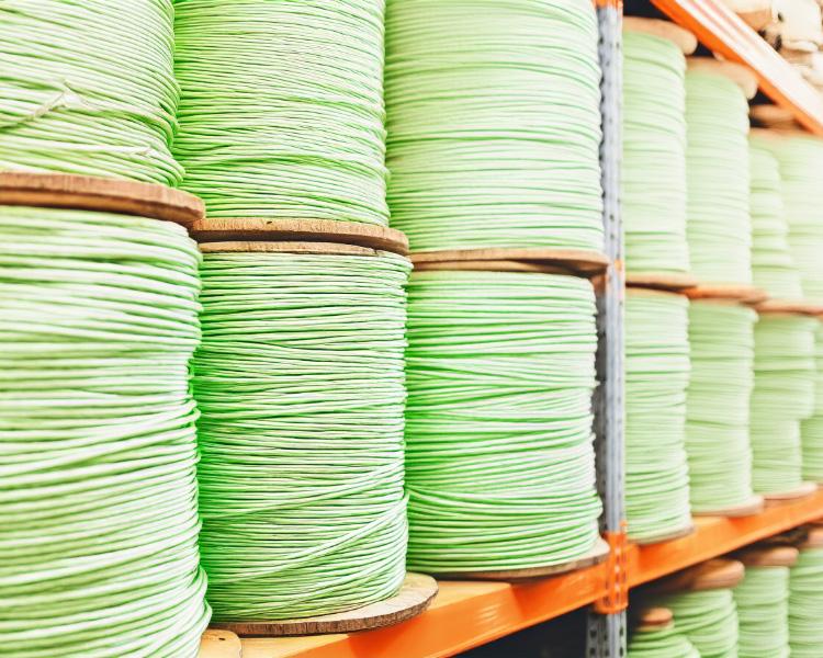 Marine-grade green rope stored on warehouse shelves, designed for outdoor and maritime use.